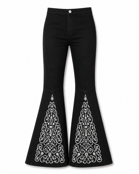 Black floral embroidered flare denim jeans against a white background.