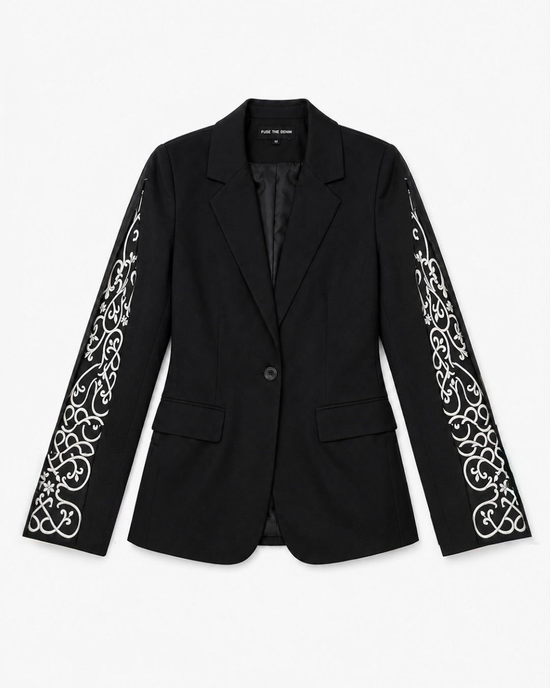 A black tailored blazer with intricate white embroidered scrollwork detailing running down both sleeves, shown against a plain light gray background.
