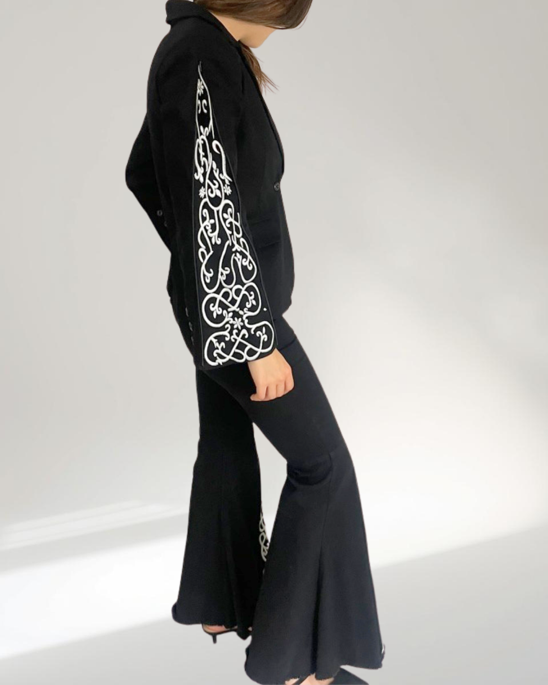 model standing sideways full length wearing blazer and jeans