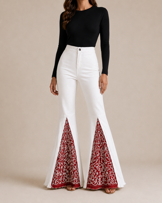 White high-waisted flare jeans with lace detailing on the bell-bottom hems, shown on a model against a light beige studio background.