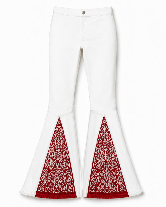 White flared pants with red and white paisley-patterned fabric panels at the lower front of each leg, shown on a plain light background.