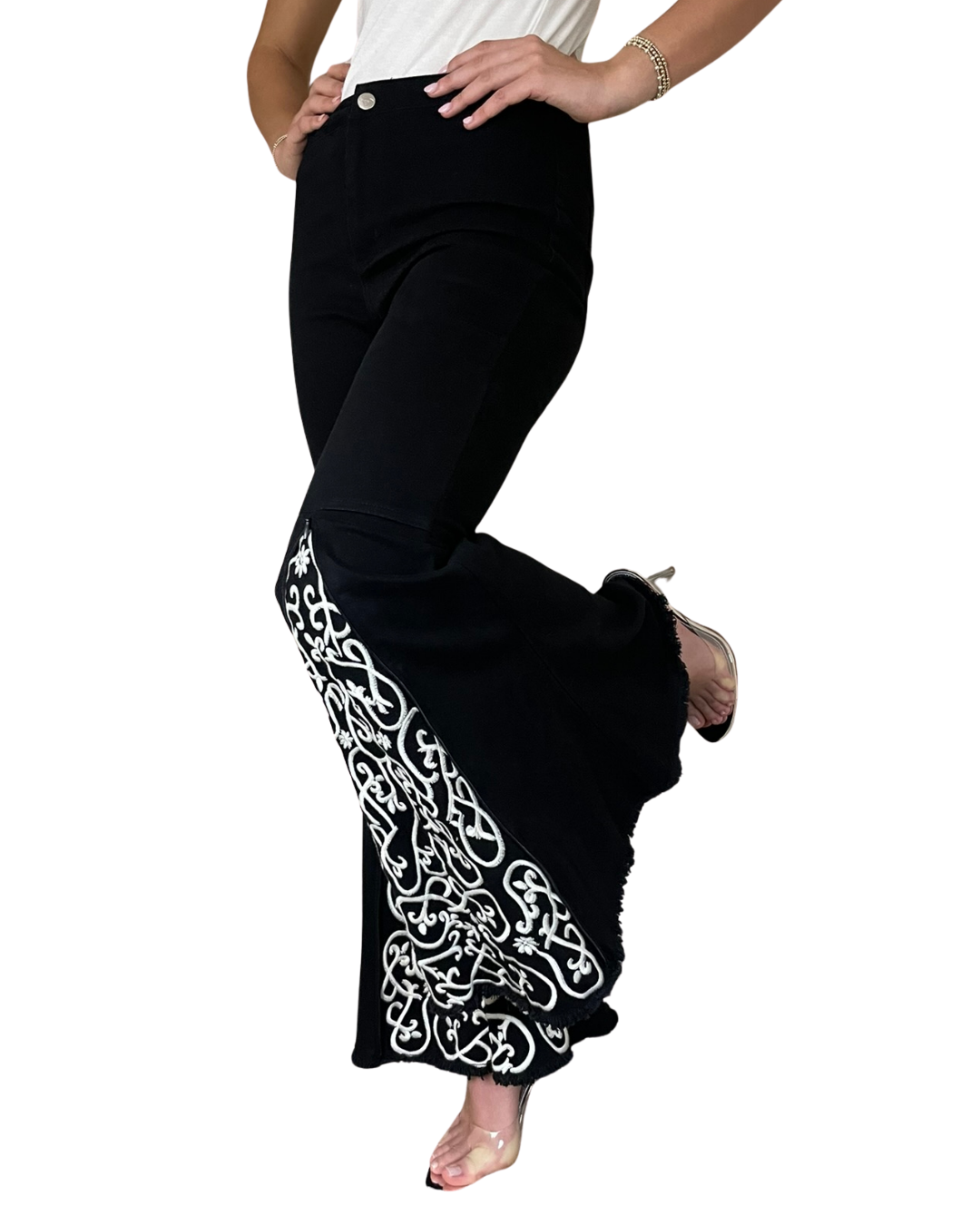 model with one leg up showing the flare of the shiftflare black jeans